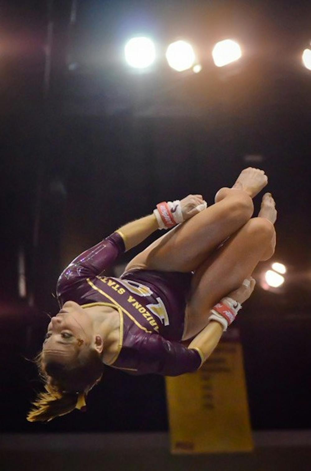 A step back: ASU freshman Samantha Seaman flies through the air during her routine on the uneven bars during the Sun Devils’ Feb. 6 dual with Oregon State. ASU posted their lowest score since Jan. 28 during their loss to No. 2 Stanford on Sunday. (Photo by Aaron Lavinsky)