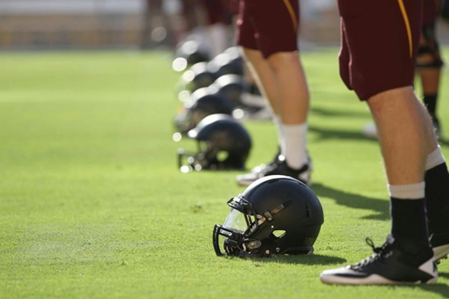 GEARING UP: ASU football players line up during a drill before last Saturday's scrimmage.  The Sun Devils will take the field for the first time this season Thursday night against UC Davis. (Photo by Lisa Bartoli)