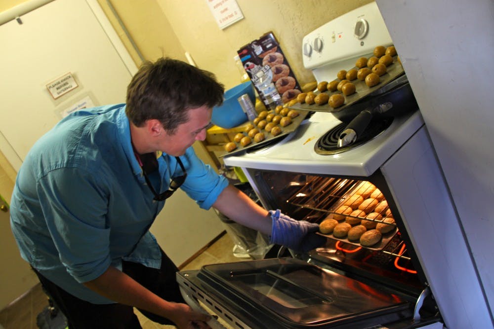 BAKING FOR A CAUSE: Sophomore Kevin Cosgrove, pledge in the Sigma Nu fraternity, makes cookies that will be sold on Mill Avenue to raise money for the Tempe Youth Resource Center. (Photo by Rosie Gochnour)