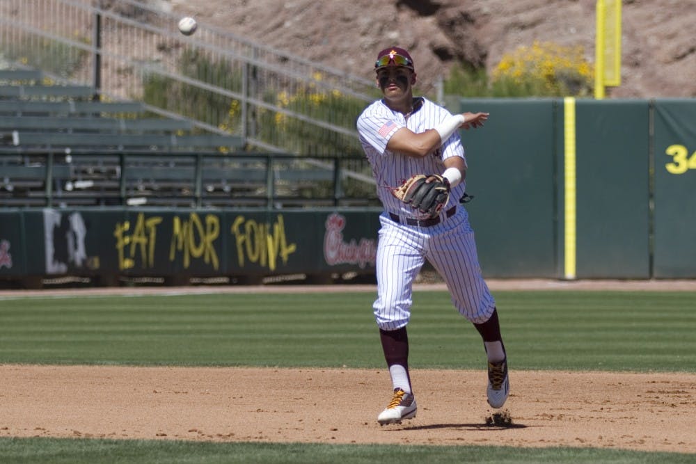 ASU freshman infielder Carter Aldrete (21) tries to throw out a runner at first base during game three of a baseball series against the Oregon State Beavers at Phoenix Municipal Stadium in Phoenix on Saturday, March 18, 2017. ASU lost 4-0.