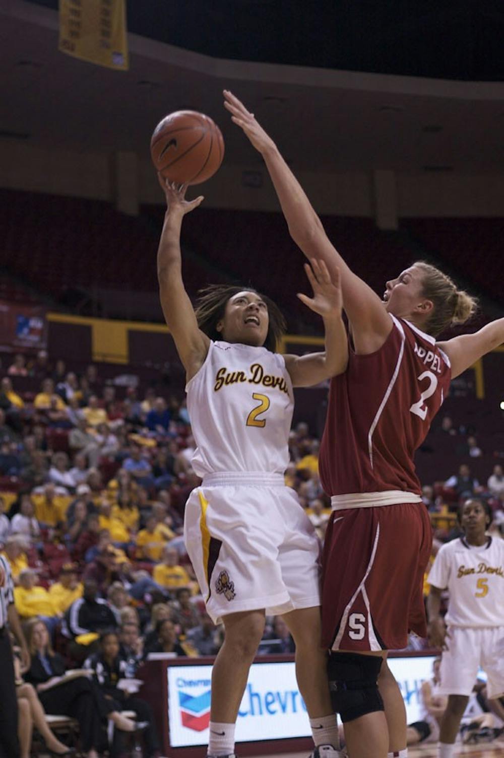 up and over: ASU freshman guard Sabrina McKinney attempts a shot over Stanford senior center Jayne Appel in the Sun Devils’ 62-43 loss to the Cardinal last month at Wells Fargo Arena. (Photo by Scott Stuk)