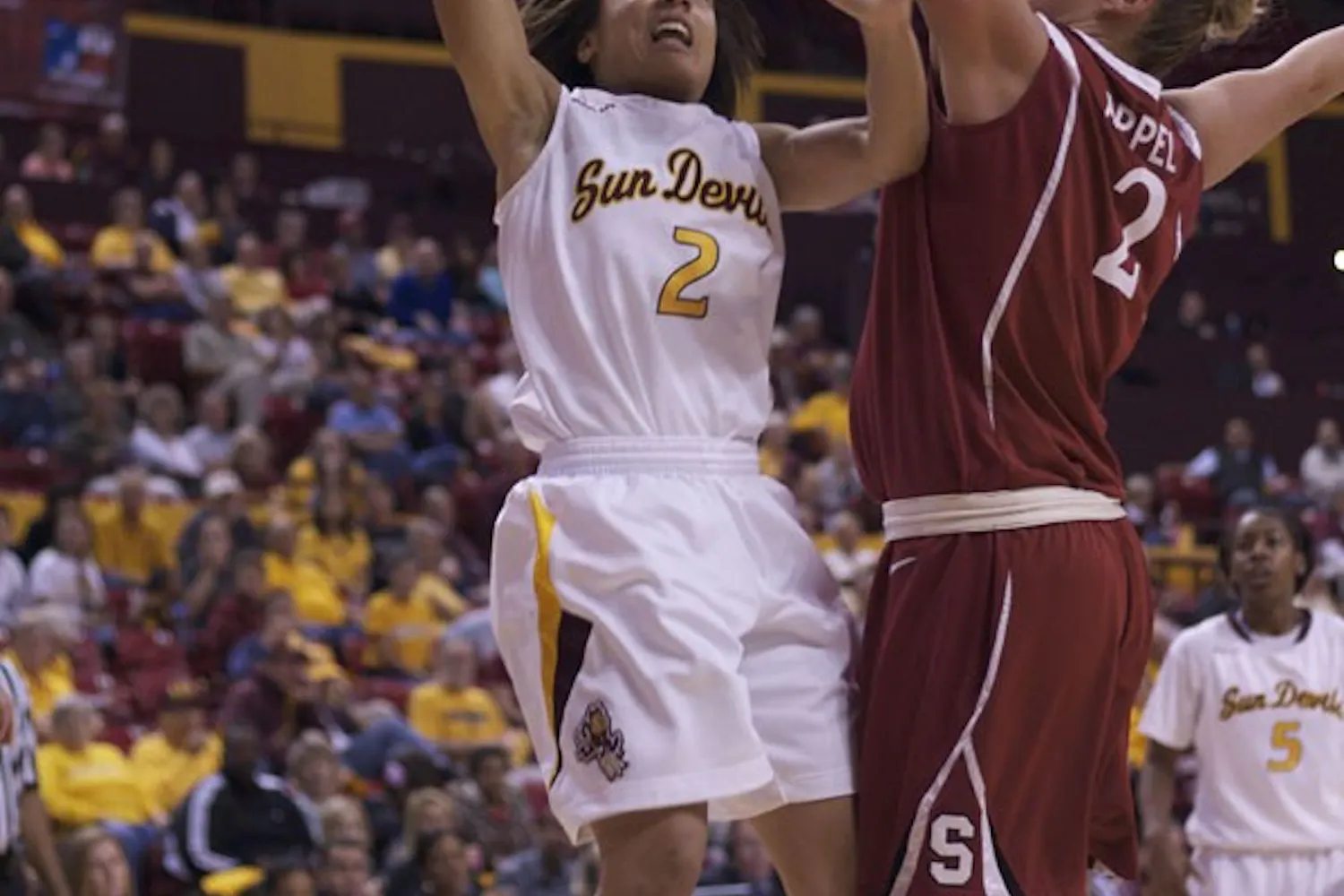 up and over: ASU freshman guard Sabrina McKinney attempts a shot over Stanford senior center Jayne Appel in the Sun Devils’ 62-43 loss to the Cardinal last month at Wells Fargo Arena. (Photo by Scott Stuk)