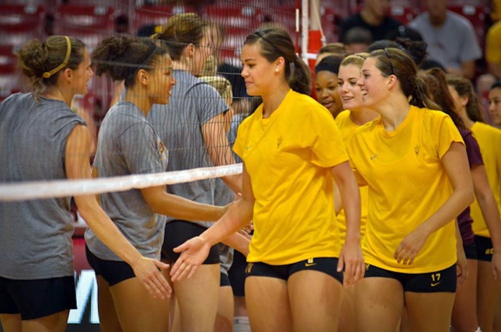 BACK IN TEMPE: Current and former members of the ASU volleyball team shake hands after the Alumnae Game in August. The Sun Devils play their first home game since Oct. 27 on Friday. (Photo by Aaron Lavinsky)