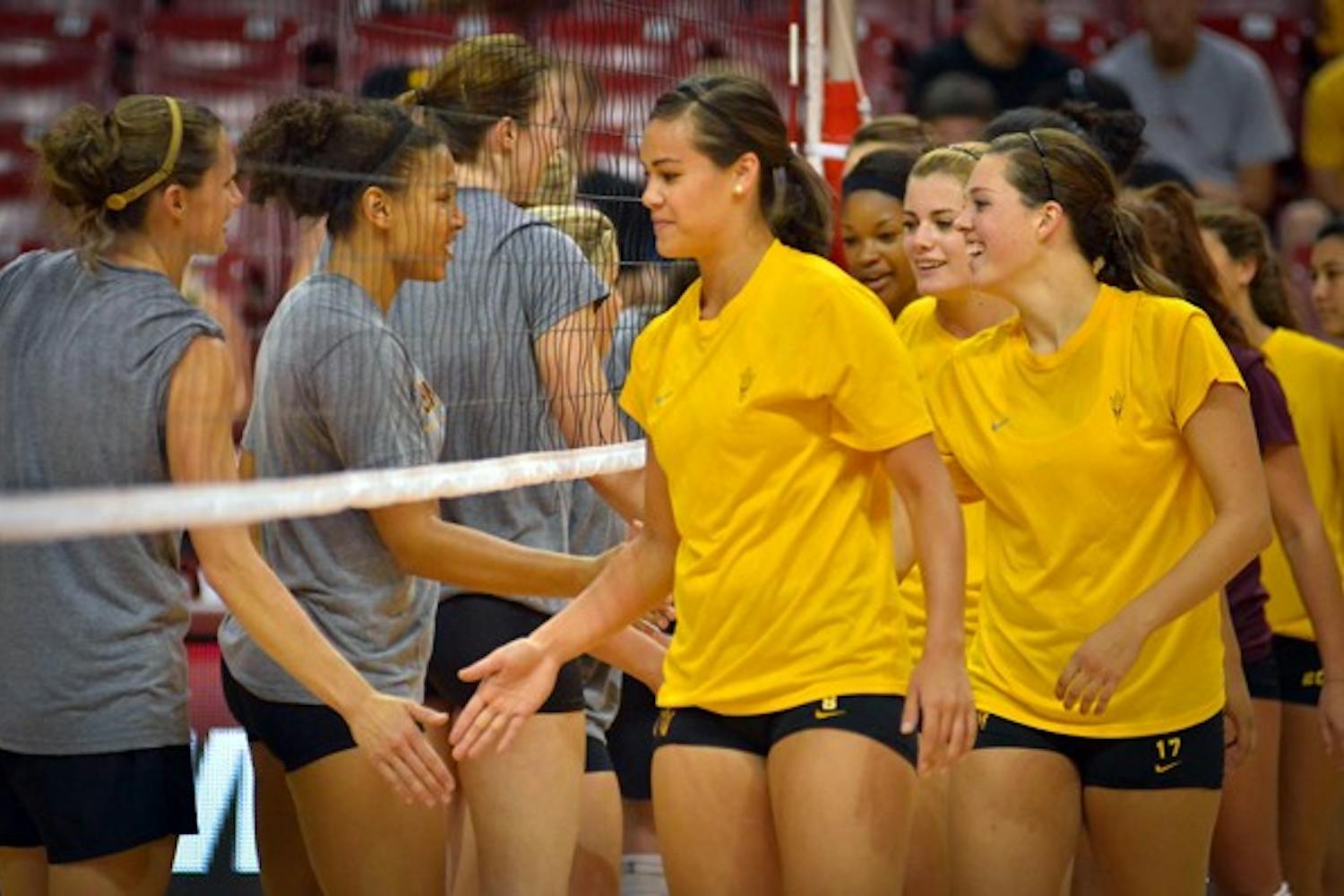 BACK IN TEMPE: Current and former members of the ASU volleyball team shake hands after the Alumnae Game in August. The Sun Devils play their first home game since Oct. 27 on Friday. (Photo by Aaron Lavinsky)