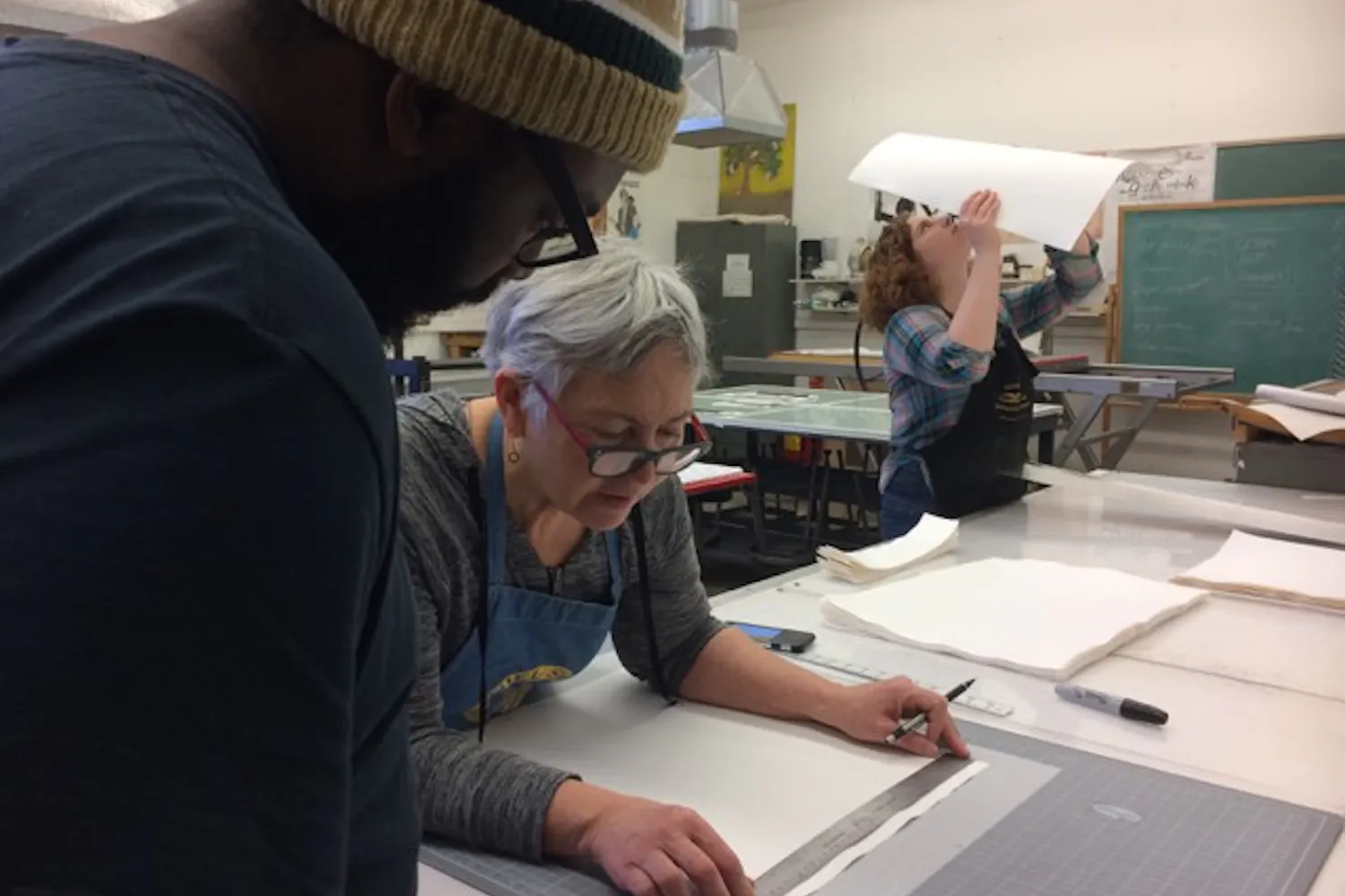 Jonathan Wright (left) works with visiting artist Brenda Mallory to create a unique work of art inspired by Mallory's Native American heritage. 