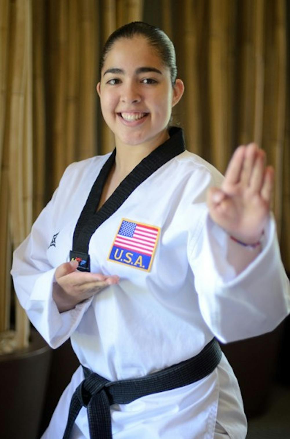 FIGHTING TO THE TOP: Exercise and wellness junior and 4th degree taekwando black belt Jenny Quezada will be competing at the international level for her second time at the World University Games in Shenzhen, China in August as a member of the US National Collegiate Team.  (Photo by Aaron Lavinsky)