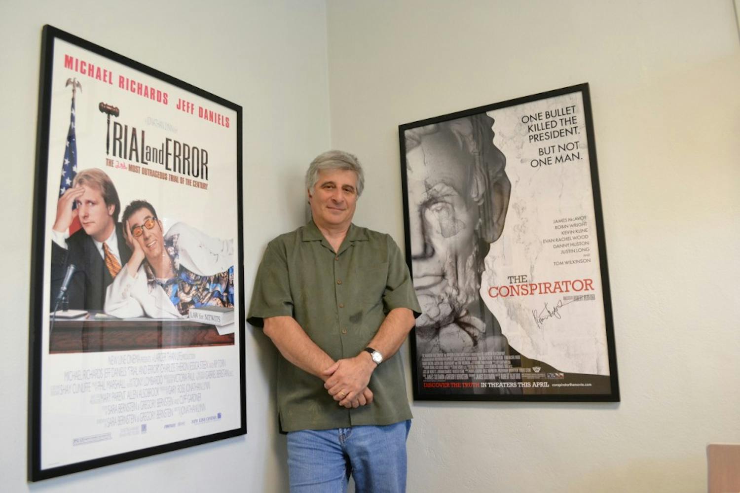 Bernstein poses between the posters of two films he has written hanging from the walls of his office.
Photo by Mackenzie McCreary
