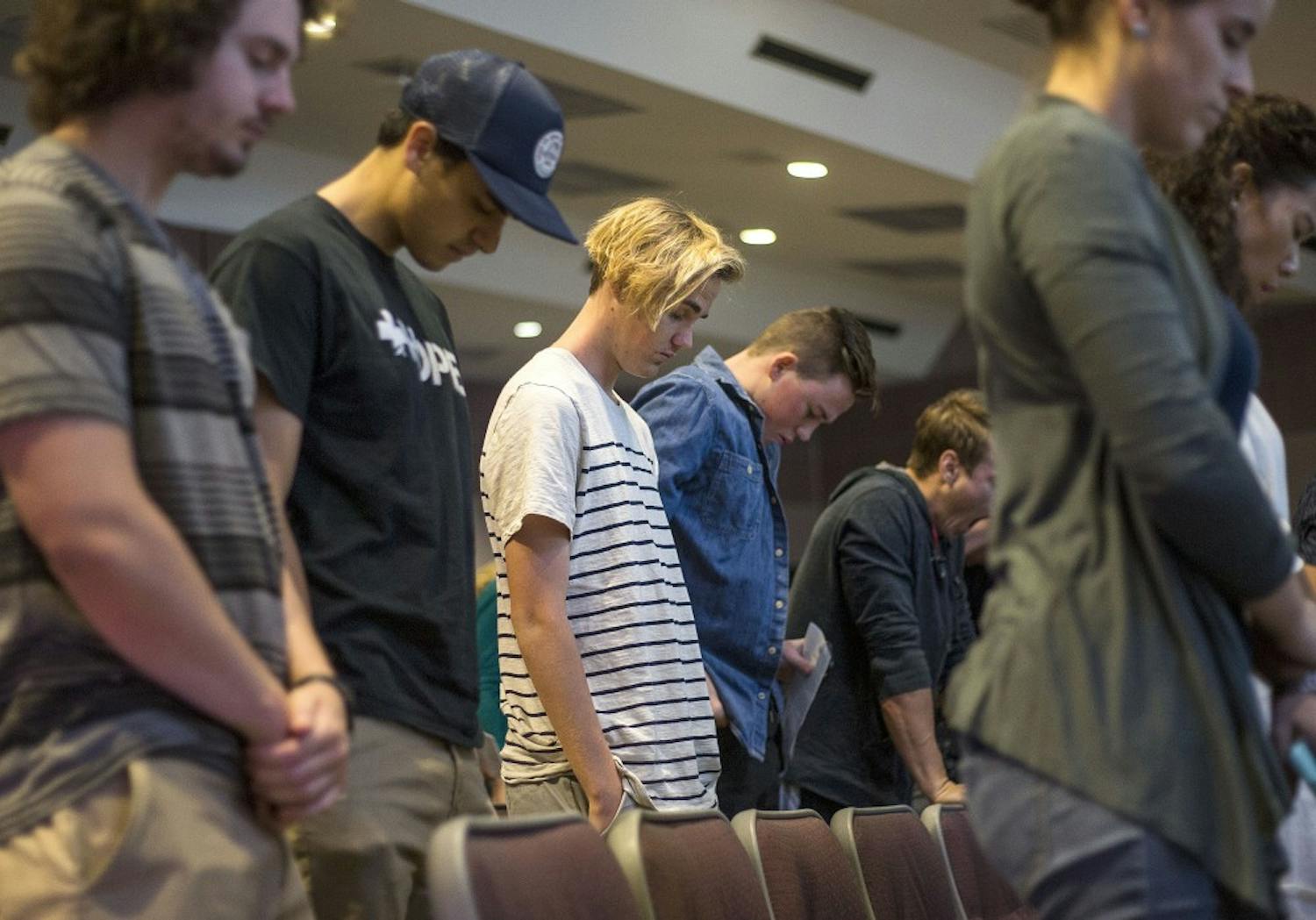 Members pray during a Hope Life Church service in Neeb Hall on the Tempe campus on Oct. 2, 2016. 