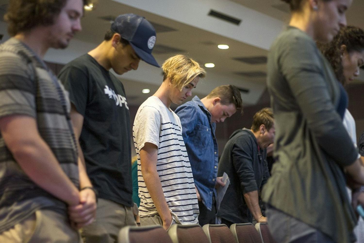 Members pray during a Hope Life Church service in Neeb Hall on the Tempe campus on Oct. 2, 2016. 