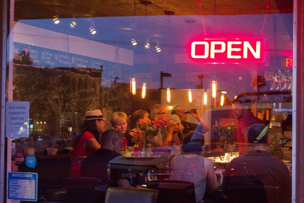 Patrons enjoy the atmosphere of The Whining Pig in Phoenix on Thursday, March 26.