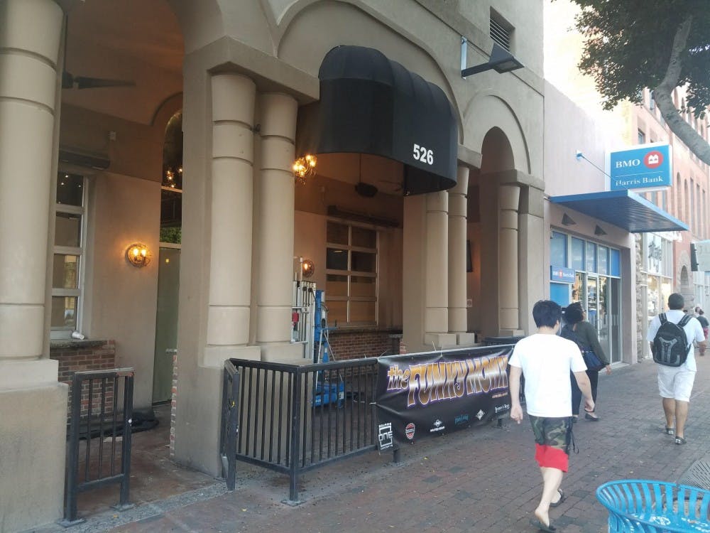 People walk by&nbsp;The Funky Monk while it&nbsp;is undergoing renovations on March 21, 2017.