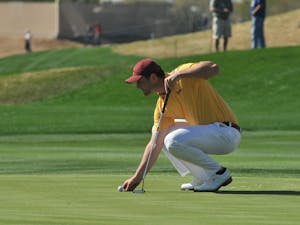 Junior Jon Rahm sets his ball on the green at the 9th hole of the 2015 Waste Management Phoenix Open on Feb. 1, 2015. (Andrew Ybanez/The State Press)