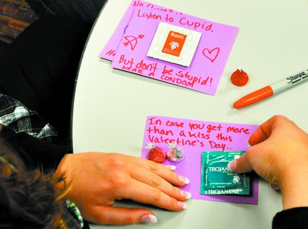 CONDOM-GRAMS: Sophomore Natalie Goldfarb, the director of internal affairs of VOX, prepares for Valentine's Day with condom-grams. VOX, "voice" in Latin, is a student organization dedicated to the advocacy and awareness of women's reproductive rights. The organization will be tabling on Monday with the handouts. (Photo by Sierra Smith)