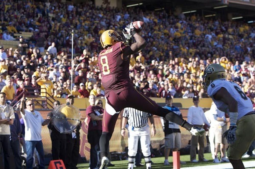 HOT HANDS: Junior wide receiver Gerell Robinson catches a touchdown pass from sophomore quarterback Brock Osweiler during Saturday's 55-34 ASU win. Entering the game after starting junior Steven Threet suffered a concussion, Osweiler threw for 380 yards and four touchdowns while also scoring on a run. (Photo by Scott Stuk)
