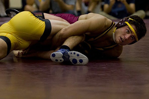Sophomore Preston McCalmon and redshirt junior Nathan Hoffer wrestle at ASU's first Wrestle Off. Guest coaches CB "The Doberman" Dollaway and Ryan "Darth" Bader were also in attendence for the event. (Photo by Diana Lustig)