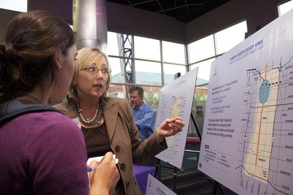 METRO MEETING: Jyme Sue McLaren (center) of the City of Tempe talks to a Tempe resident about the MAG Regional Transportation Plan which was part of the Tempe South High Capacity Transit Study. (Photo by Scott Stuk)