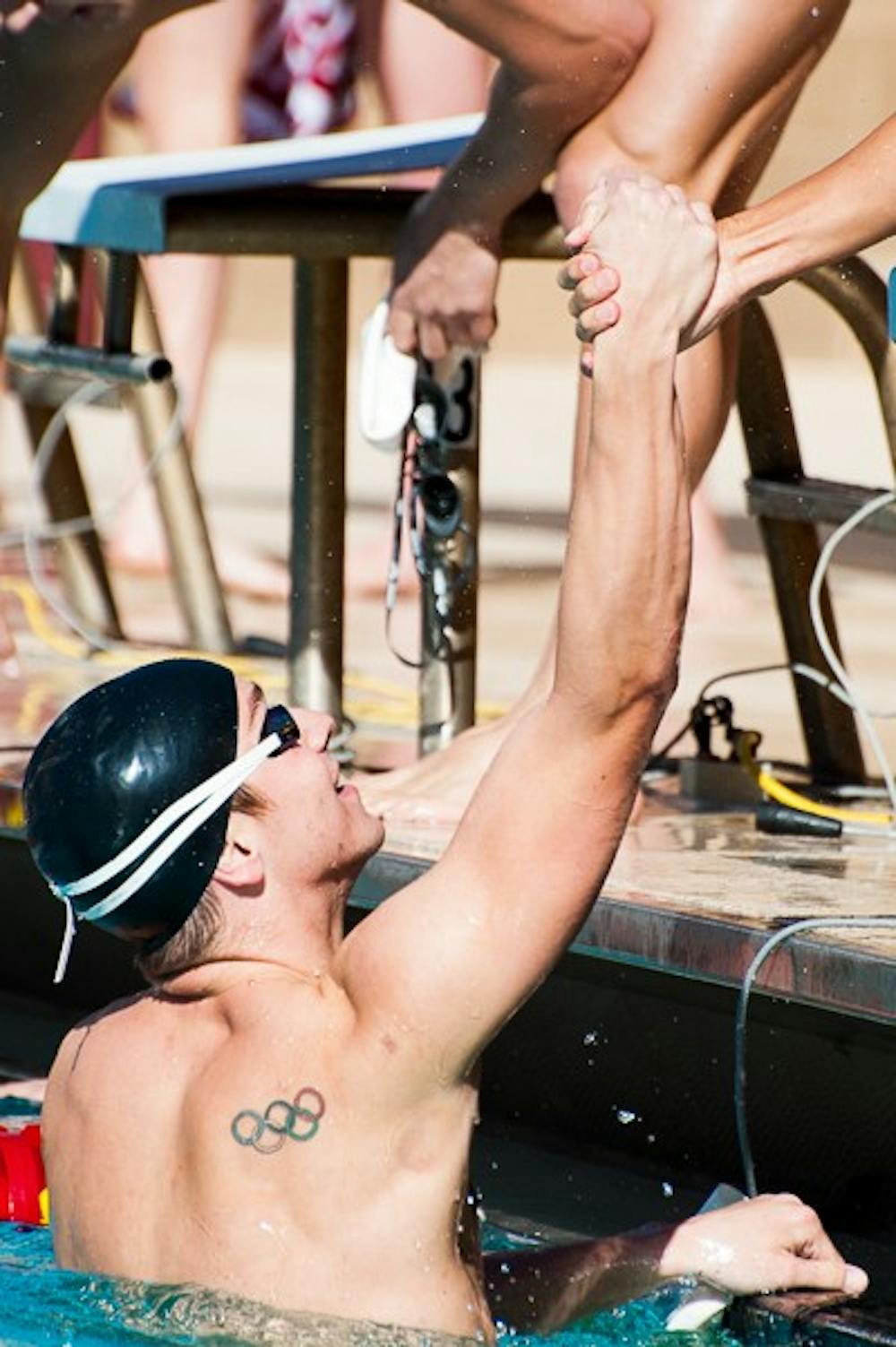 Sophomore Richard Bohus celebrates with a teammate after winning the men's 200-yard freestyle relay against Stanford, Saturday, Jan. 24, 2015 at the Mona Plummer Aquatics Complex in Tempe. The men's team fell to Stanford 134-96. (Ben Moffat/The State Press)