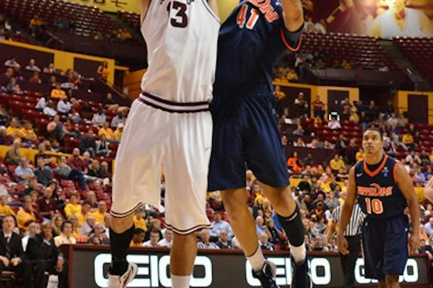 FIRED UP: Senior guard Ty Abbott puts up a shot over an Oregon defender last season. After earning First Team All-Pac-10 honors last year, Abbott returns as the Sun Devils' primary leader. ASU men's basketball opens the season Tuesday night in Albuquerque, N.M., against UNM. (Photo by Scott Stuk)