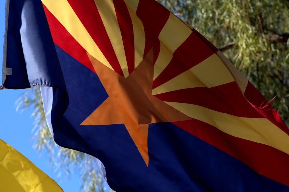 The Arizona state flag flys outside of the Capitol building on Wednesday, March 23, 2016. 