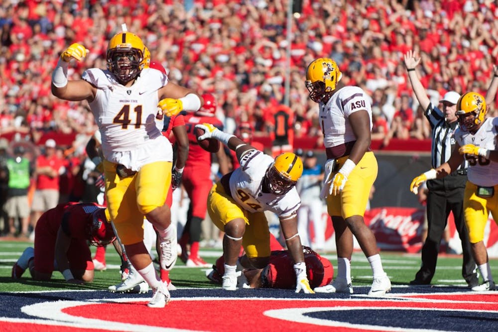 Redshirt junior defensive end Demetrius Cherry scores a touchdown after recovering a fumble in a game against the University of Arizona, Friday, Nov. 28, 2014 at Arizona Stadium in Tucson. The Wildcats defeated the Sun Devils 42-35. (Photo by Ben Moffat)