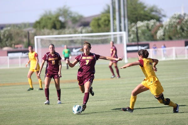 Redshirt senior midfielder Courtney Tinnin (7) takes a shot as freshman midfielder Tommi Goodman (5) looks on during the Sun Devils’ 5-4 double overtime win over USC on Sept. 28. (Photo by Kyle Newman)