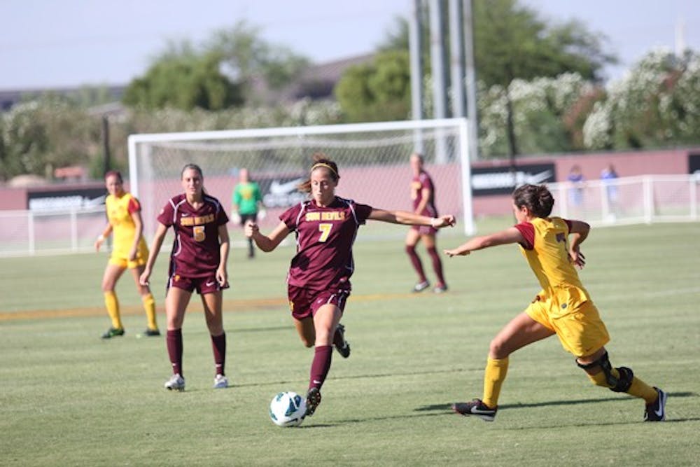 Redshirt senior midfielder Courtney Tinnin (7) takes a shot as freshman midfielder Tommi Goodman (5) looks on during the Sun Devils’ 5-4 double overtime win over USC on Sept. 28. (Photo by Kyle Newman)
