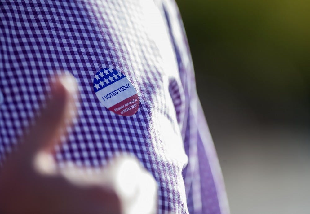 A voter speaks to volunteers after exiting a polling location in the Sun Devil Fitness Complex on the ASU Tempe campus on Tuesday, Nov. 8, 2016. 