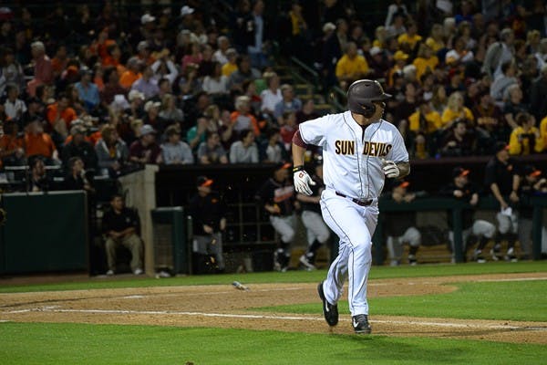 Junior catcher RJ Ybarra runs to first base after a base hit during the second inning of a game against Oklahoma State, Friday, Feb. 13, 2015, at Phoenix Municipal Stadium. (J. Bauer-Leffler/The State Press)