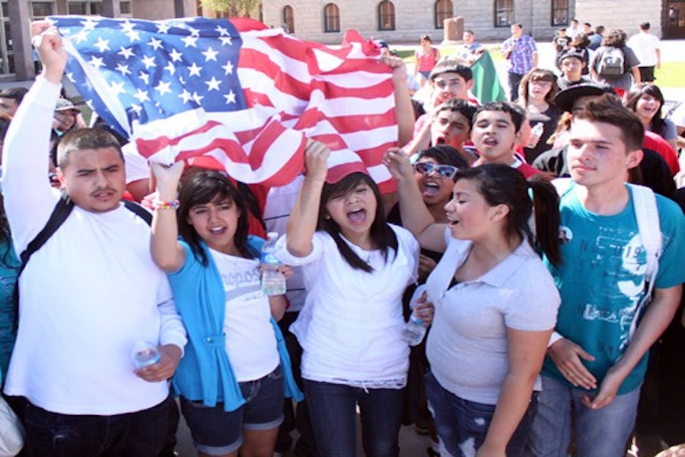 High school and college students gathered at the state Capitol Friday to protest a bill that would require illegal immigrants to show proof of citizenship before enrolling a child in an Arizona school. The demonstration was organized through text messaging and social media sites. (Photo by Beth Easterbrook) 
