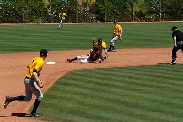 Freshman infielder/outfielder Dalton DiNatale slides safely into second in a home game against California on April 13, 2014. (Photo by Mario Mendez)