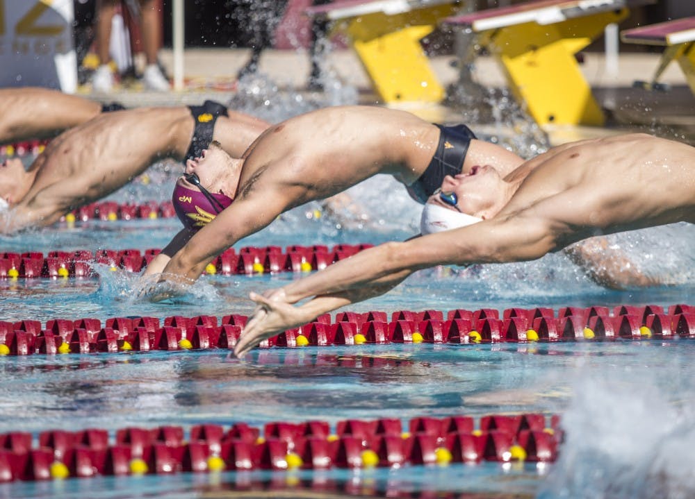 Elliott Reid, center, kicks off the 200-yard individual medley at the Mona Plummer Aquatic Center in Tempe, Ariz., on Friday, Nov. 6, 2015. The USC men's team beat ASU 159-139 and the USC women beat ASU 178-106.