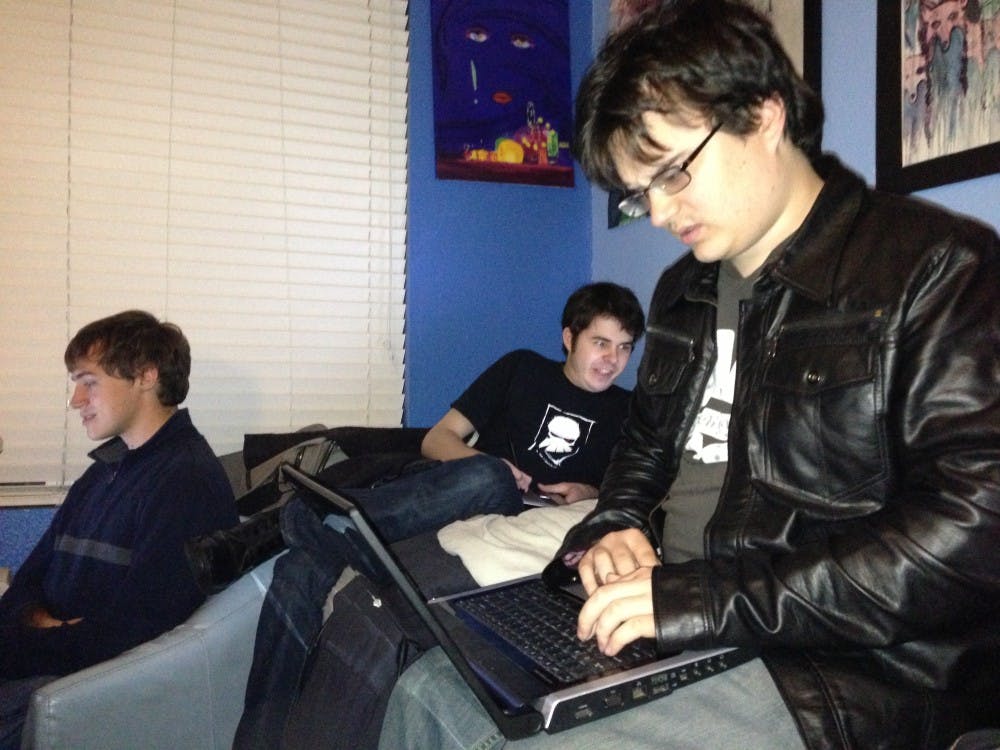 (From left to right) Branden, Alex and J.T. are all hard at work, putting the finishing touches on their game. Meanwhile, Brianna (not pictured) directs the action and works to ensure all is well. Photo by Preston Sotelo