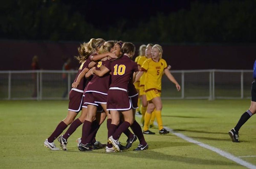 CLUTCH FINISH: Members of the ASU women's soccer team celebrate a goal during Friday's 3-0 upset of No. 17 Southern California. The Sun Devils had more to celebrate, as they likely earned a trip to the NCAA tournament. Tournament selections will be announced Monday. (Photo by Aaron Lavinsky)