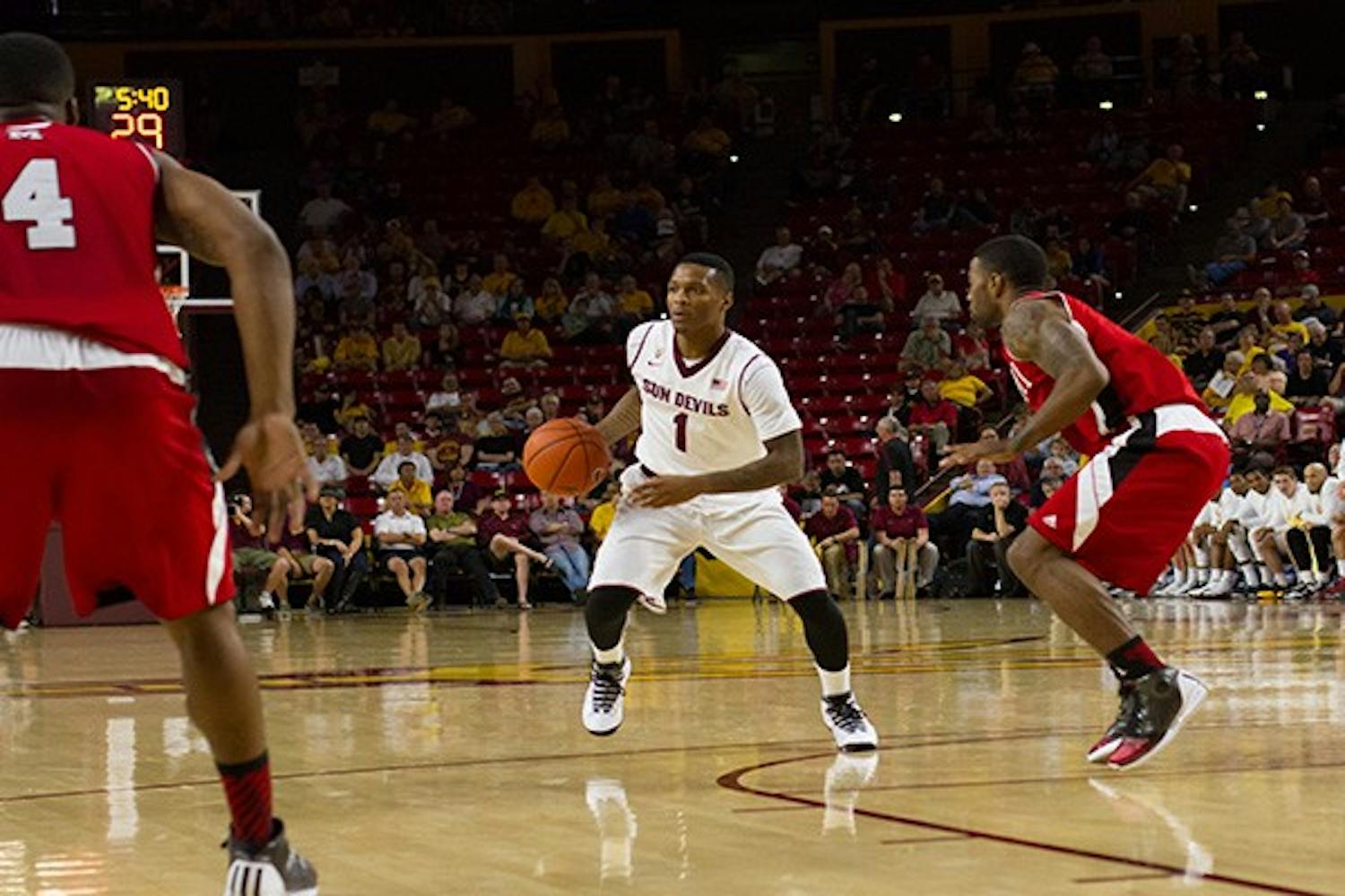Sophomore guard Jahii Carson dribbles the ball up the court between defenders against Miami (Ohio). The Sun Devils won 94-50. (Phoot by Vince Dwyyer)