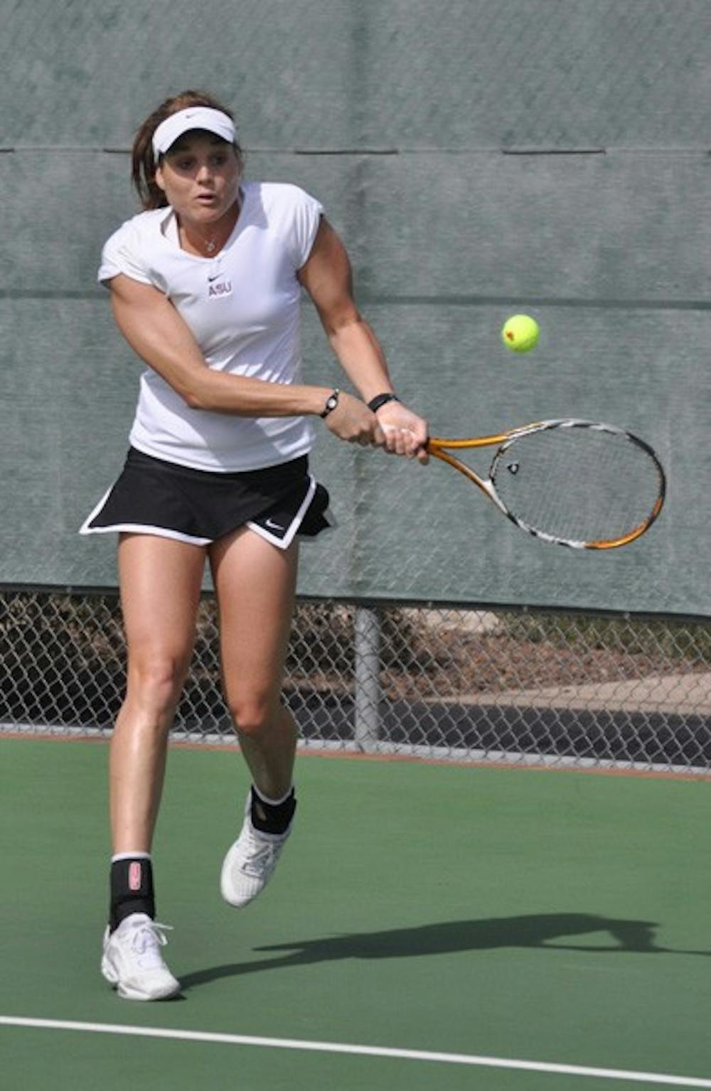 Giant killers: ASU senior Ashlee Brown returns a forehand during the Sun Devils’ dual against UC Davis on Jan. 23. No. 21 ASU recently knocked off two top-10 teams, including No. 9 USC in Los Angeles, and plays three matches this week. (Photo by Michael Arellano)