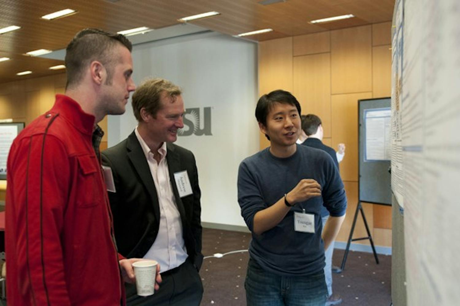 Graduate student  Youngjae Kim (right) presents his research project on the current status and future direction for nanotechnology regulations to graduate student Jathan Sadowski (left) and Andrew Maynard (center) with the board for the Center for Nanotechnology in Society at ASU. Several graduate students met at the MU on Friday to present their projects to members of the board. (Photo by Molly J Smith) 