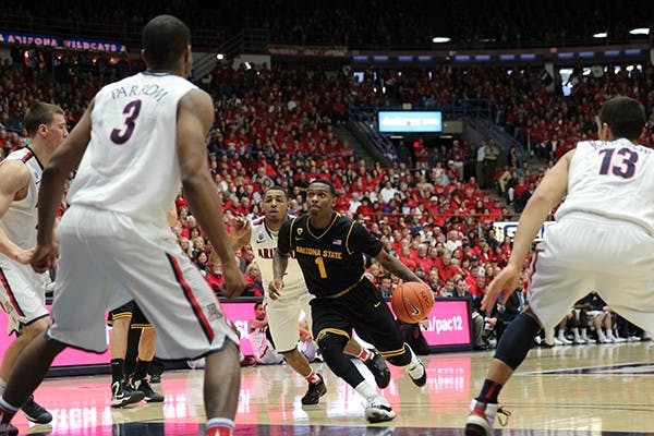 Sophomore Jahii Carson maneuvers through members of the UA team during a men's basketball game. With the start of the season, Carson hopes he can take the team to a NCAA tournament berth. 9Photo by Dominic Valente)