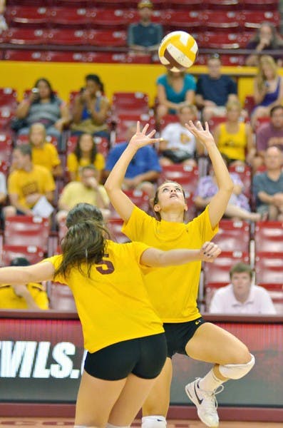 WELCOME BACK: ASU sophomore setter Sarah McGaffin (right) makes a set while sophomore middle blocker Alexis Pinson looks on. The Sun Devils return to conference play against old foes Oregon and Oregon State this weekend. (Photo by Aaron Lavinsky)