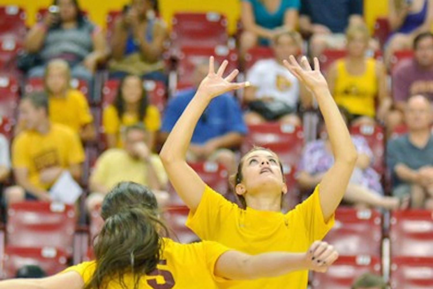 WELCOME BACK: ASU sophomore setter Sarah McGaffin (right) makes a set while sophomore middle blocker Alexis Pinson looks on. The Sun Devils return to conference play against old foes Oregon and Oregon State this weekend. (Photo by Aaron Lavinsky)