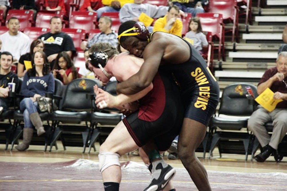 Kevin Radford grapples with an opponent in a Feb. 5 meet against Stanford. Radford and the Sun Devils came away with a 22–15 victory. (Photo courtesy of Jeremy Hawkes)
