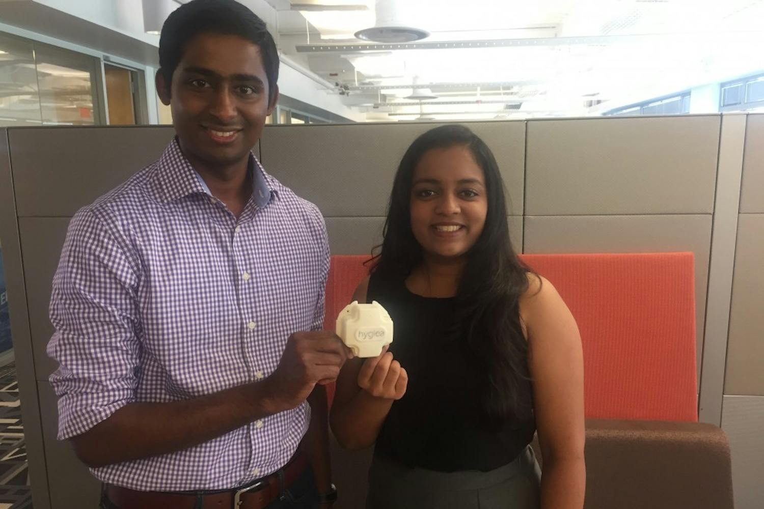 Saiman Shetty (Left) and Pooja Addla Hari (Right) hold a model of one of Hygiea's sensors in Skysong1 on April 21, 2017.&nbsp;
