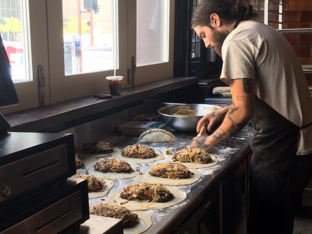 Mike Pinon prepares Royale pasties at the Cornish Pasty Co. downtown Phoenix location on Wednesday, April 12, 2017. He described the dish as "pretty much a cheeseburger inside of a pasty."