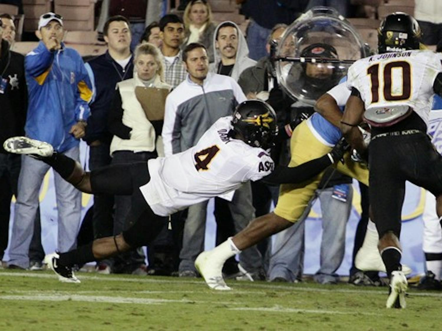 AIR ATTACK: ASU sophomore Alden Darby (4) dives to make a tackle while junior safety Keelan Johnson arrives in support during the Sun Devils’ 29-28 loss to UCLA. The Sun Devil defense gave up an uncharacteristic 503 yards passing during Saturday’s loss to Washington State. (Photo by Beth Easterbrook)