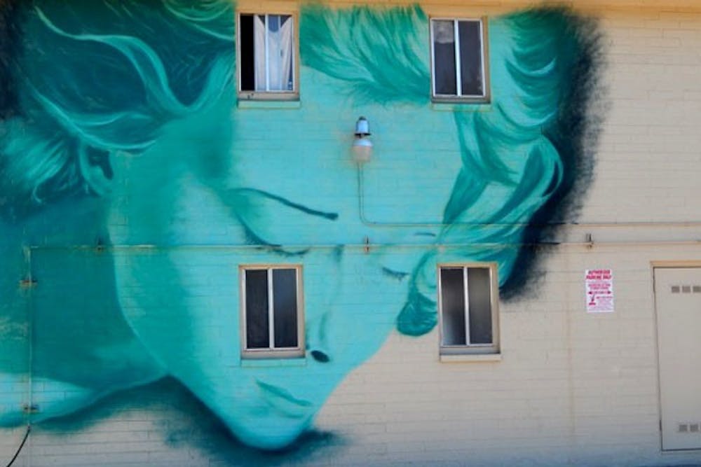 It’s a case of when Heaven meets Earth in the piece ‘Woman in a Dream’ as she watches over the residents of a downtown Tempe apartment building. (Photo by Olivia Richard)
