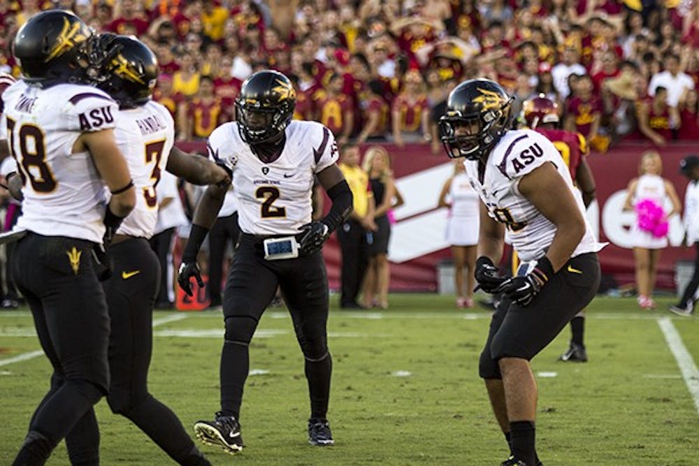 ASU redshirt sophomore linebacker Salamo Fiso celebrates a sack with teammates. (Photo by Alexis Macklin)