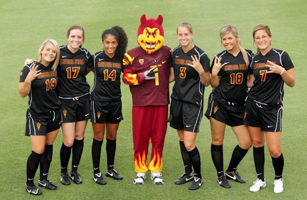 LAST STAND: ASU senior soccer players (from left to right) Kari Shane, Kate Sangster, Nicole Acosta, Sierra Cook and redshirt juniors Courtney Giovanni and Courtney Tinnin pose with Sparky before a game. All but Tinnin will play their final games as Sun Devils on Friday against UA. (Photo by Beth Easterbrook)