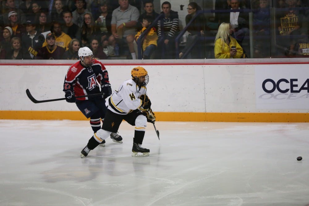 Faiz Khan of ASU attempts to reclaim control of the puck during a game at Oceanside Ice Arena. ASU defeated the University of Arizona team 5-1. 