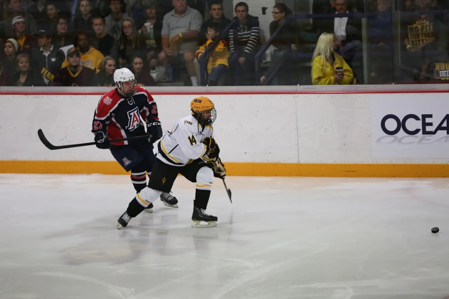 Faiz Khan of ASU attempts to reclaim control of the puck during a game at Oceanside Ice Arena. ASU defeated the University of Arizona team 5-1.