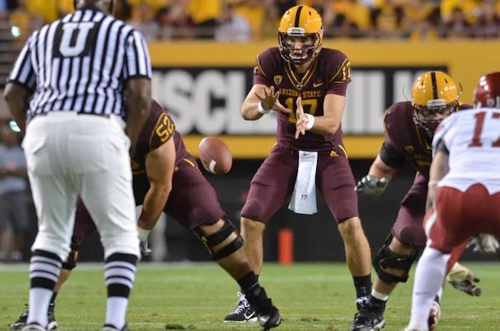 EXTRA REPS: Sophomore quarterback Brock Osweiler takes a snap during ASU's 42-0 victory over Washington State on Oct. 30. Osweiler took reps with the first team during Monday's practice, but coach Dennis Erickson said redshirt junior Steven Threet will continue to be the starter during Monday's press conference. (Photo by Aaron Lavinsky)