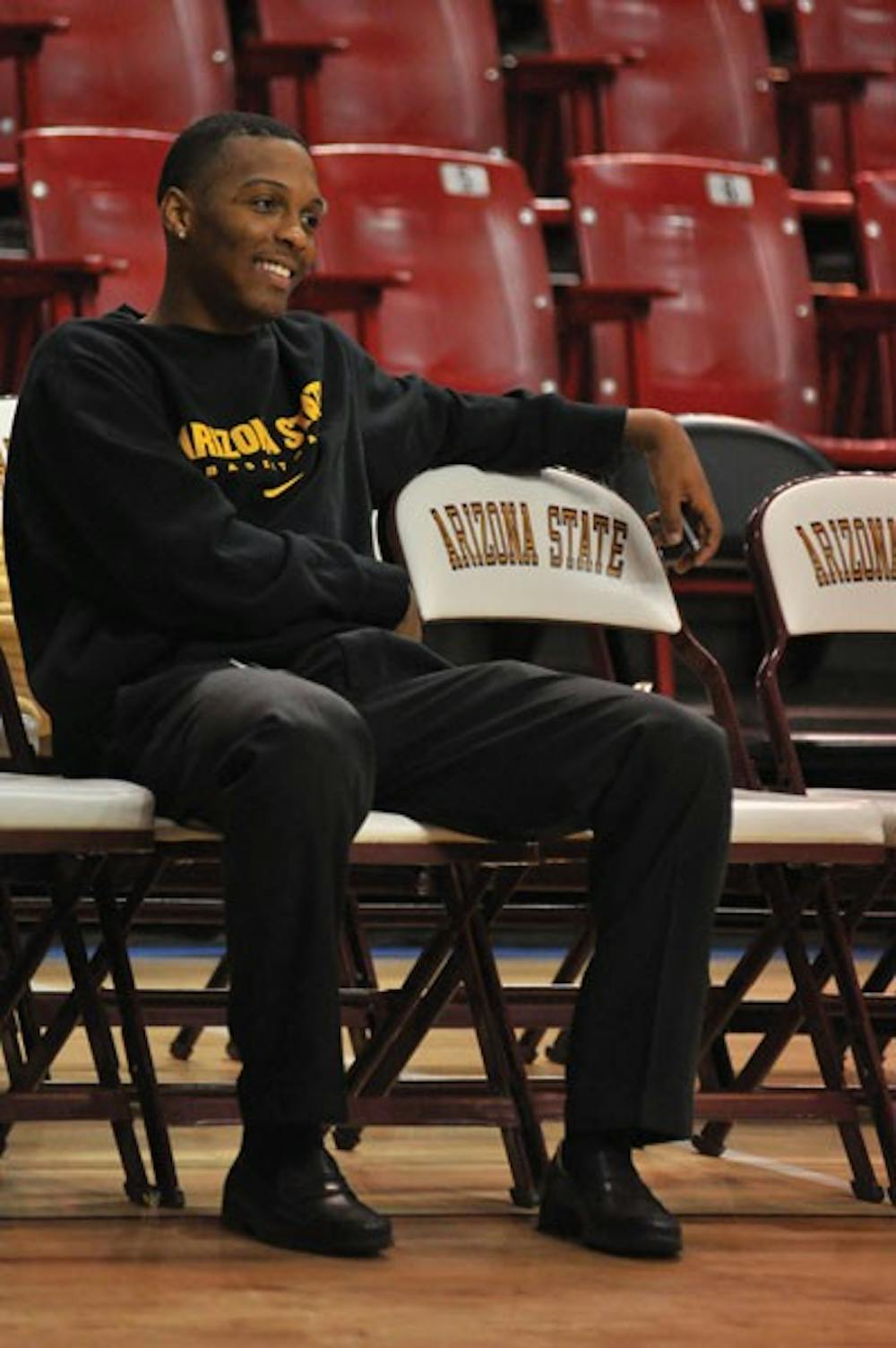 Redshirt freshman guard Jahii Carson waits on the bench during a photo shoot in February. (Photo by Aaron Lavinsky)